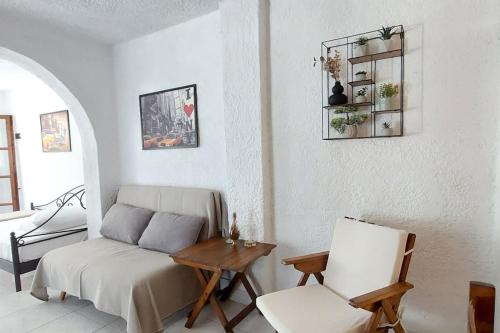 a room with a bed and a table and a chair at Esperides Villa in Sani Beach