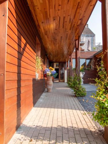 a building with a wooden ceiling and a walkway at Gite les bons amis in Plombières