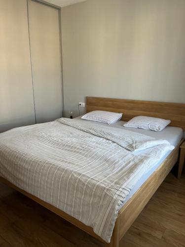 a bed with two pillows on it in a bedroom at Apartman Usmev in Košice