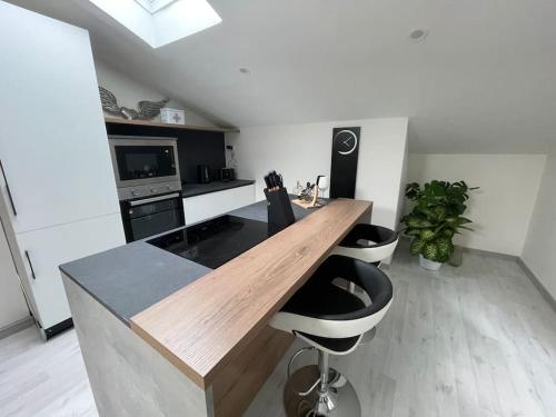 a kitchen with a wooden counter top in a room at Attico the Queen2 in Caravaggio