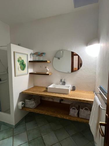 a bathroom with a sink and a mirror at Casa Nocilla, un dammuso sul mare! in Pantelleria