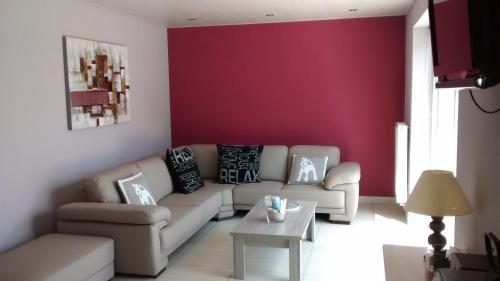 a living room with a couch and a table at De Lekkermond in Diksmuide