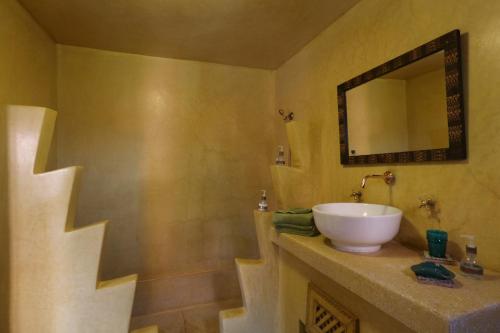 a bathroom with a sink and a mirror at Ryad El Borj in Marrakech