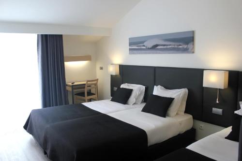 Ένα ή περισσότερα κρεβάτια σε δωμάτιο στο Hotel M