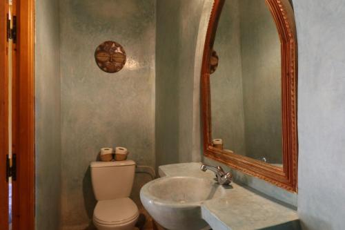 a bathroom with a sink and a toilet and a mirror at Ryad El Borj in Marrakech