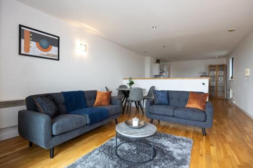 a living room with two blue couches and a table at Stunning Duplex Apartment, Free Parking For 2, WI-FI, Central Location, Long Term Disc in Manchester