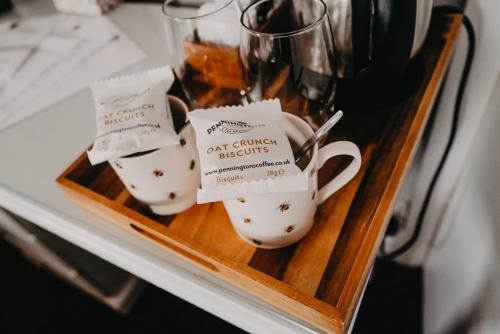 a couple of cups on a tray on a table at Goodwin House in Keswick