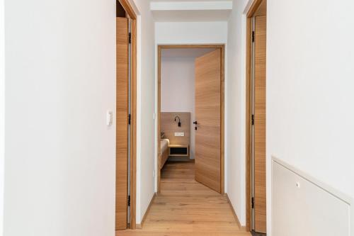 a hallway leading to a bathroom in a house at Mountain Meadows Apt 2 in Valdaora