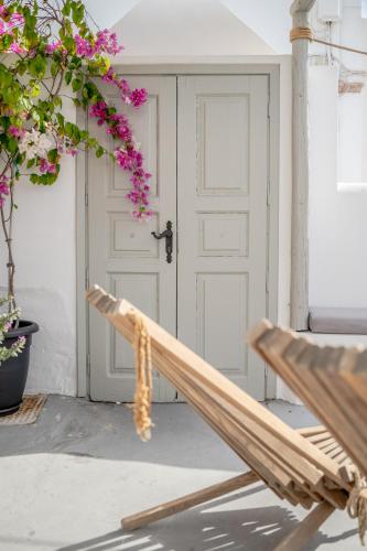 a wooden bench sitting in front of a door at Kampanario Luxury Two-Bedroom Villa with Private Jacuzzi in Megalokhori