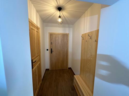 an empty room with a door and a hallway at Apartamenty u Mocarnego in Szaflary