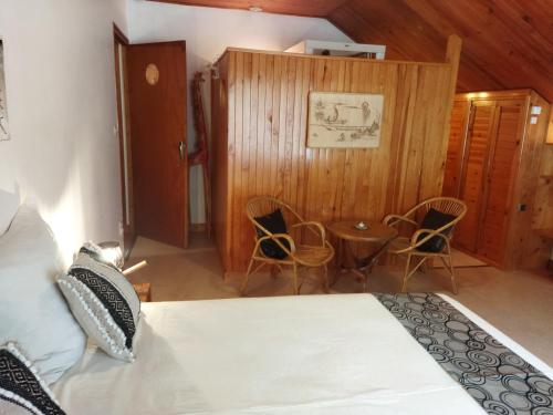 a bedroom with a bed and a table and chairs at NOMAD ALP B&B in Marthod