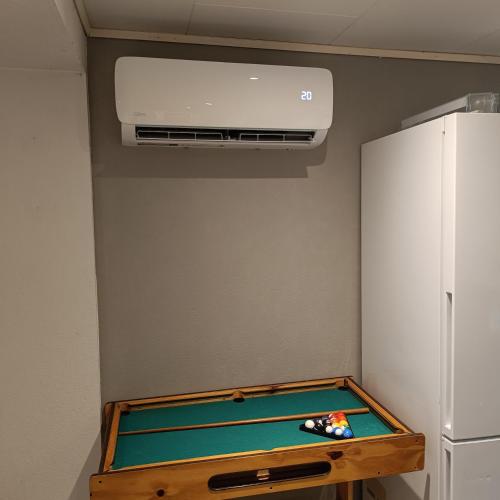 a pool table in a room with a refrigerator at Malvik, Hundhamaren, Trondheim in Malvik