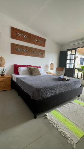 a bedroom with a large bed and a window at HOTEL RENASCI PALOMINO in Palomino