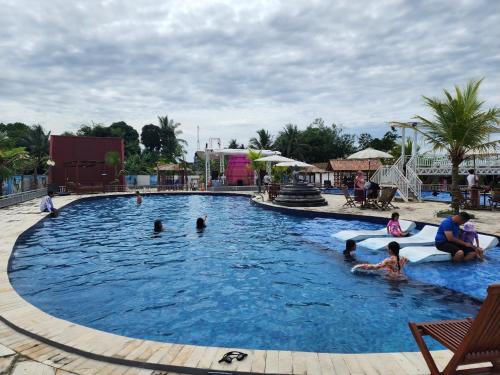 eine Gruppe von Personen in einem Schwimmbad in der Unterkunft BnB House Villa Jogja in Balong