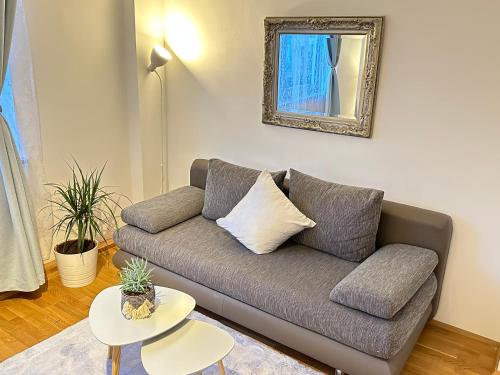 a living room with a couch and a table at The Peaceful Garden Stay & Free Parking in Salzburg