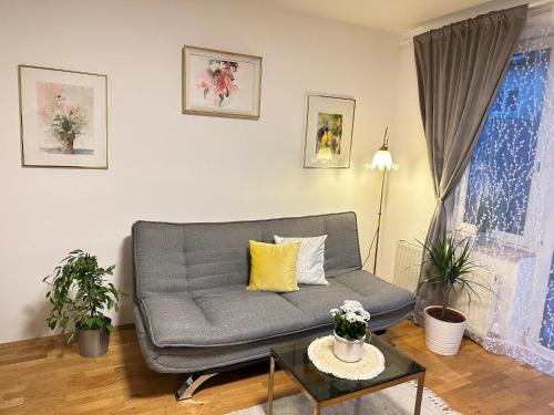 a living room with a couch and a table at The Peaceful Garden Stay & Free Parking in Salzburg