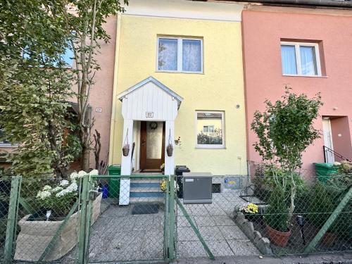 a house with a doghouse on the front of it at The Peaceful Garden Stay & Free Parking in Salzburg