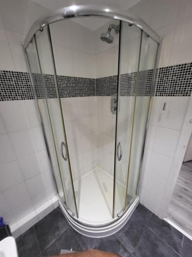 a shower with a glass door in a bathroom at Cosy 2 Bedroom flat in Grays in Grays Thurrock