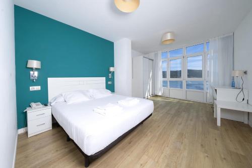 Ένα ή περισσότερα κρεβάτια σε δωμάτιο στο Hotel Mar de Fisterra