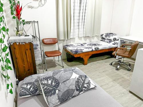 a room with a bed and a couch and a chair at Affordable Condo beside Ayala Mall Bacolod! in Bacolod