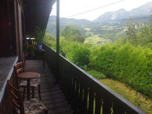 a balcony with a table and chairs and mountains at NOMAD ALP B&B in Marthod
