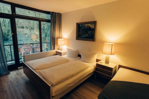 a hotel room with a bed and a window at Gasthof Hotel zur Post in Egloffstein