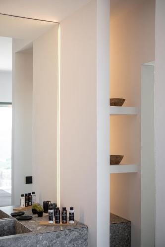 a room with white walls and a counter with shelves at Brand new Villa Eleftheria BY APOKORONAS-VILLAS in Plaka