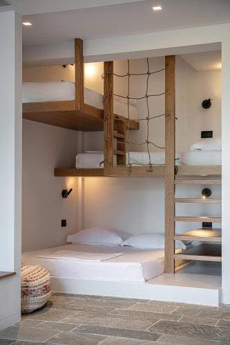 a bunk bed room with several beds in it at Brand new Villa Eleftheria BY APOKORONAS-VILLAS in Plaka