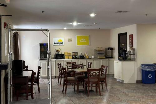 a restaurant with a table and chairs in a room at Days Inn & Suites by Wyndham Eunice in Eunice