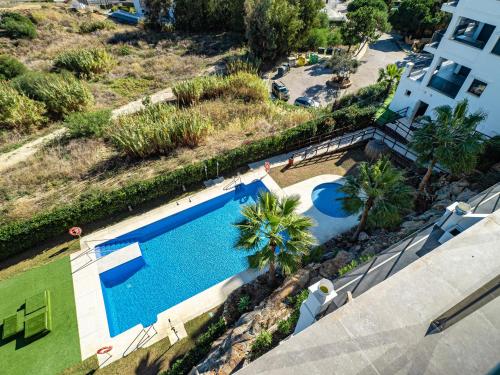 an overhead view of a swimming pool next to a house at Luxury duplex with sea views Blue Suite 3-303 in Manilva
