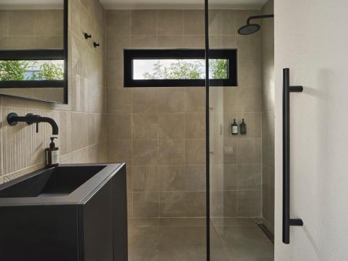a bathroom with a shower and a sink at The Newel Psychiko in Athens