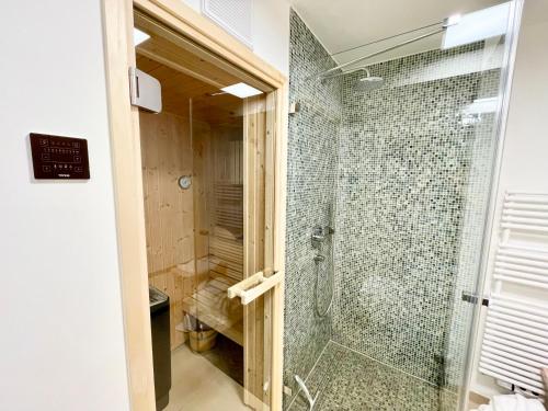 a bathroom with a shower with a glass door at Seeadler mit Meerblick in Binz