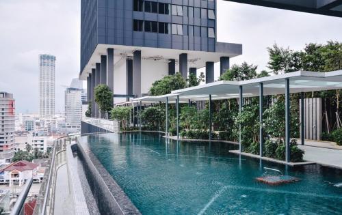 a swimming pool on the side of a building at Tropicana 218 Macalister Sea & City View by stayCATion Homestay in George Town