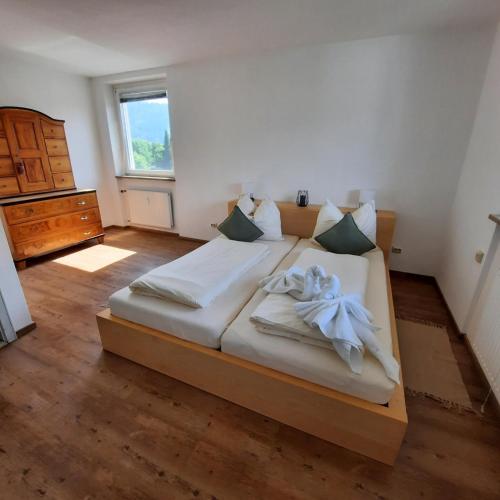 1 dormitorio con 1 cama grande y toallas. en Allgäu Auszeit, en Sonthofen