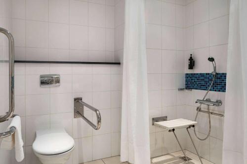 a bathroom with a toilet and a shower at Vienna House Easy by Wyndham Bratislava in Bratislava