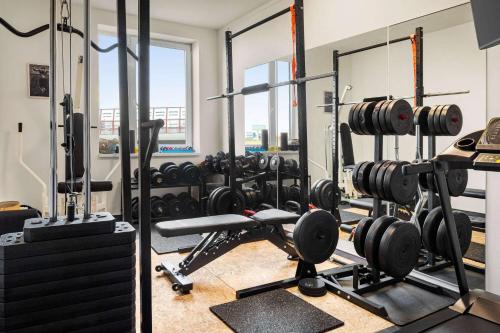 a gym with a lot of equipment in it at Vienna House Easy by Wyndham Bratislava in Bratislava