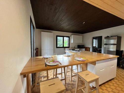 a kitchen with a large wooden table with chairs at Belle maison de 140 m2 in Villard-de-Lans