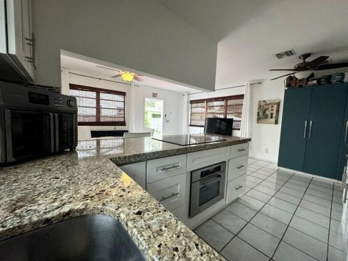 a kitchen with granite counter tops and a stove top oven at Beautiful Home in Florida in Hollywood