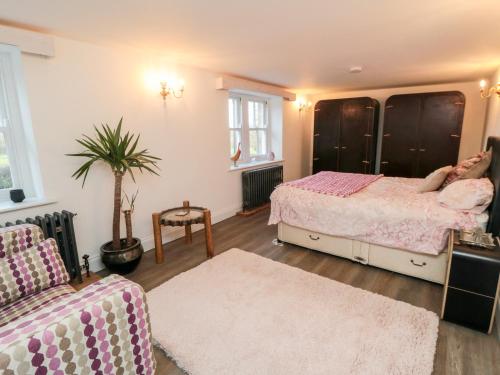 a bedroom with a bed and a couch at The Grange in Whitby