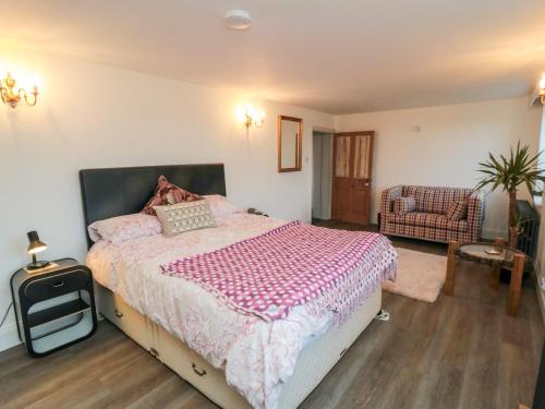 a bedroom with a bed and a chair in it at The Grange in Whitby