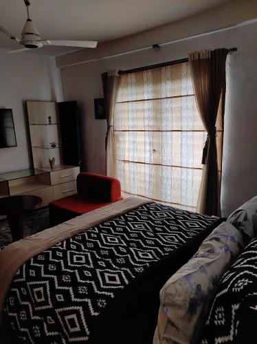 a bedroom with a bed and a window at The Beach House in Chennai