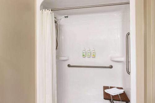 a bathroom with a shower with a refrigerator at Atlantic Host Hotel, Trademark Collection by Wyndham in Bathurst