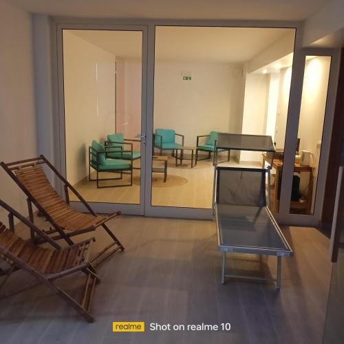 a view of a waiting room with chairs and tables at mya luxury rooms and wellness in Melendugno