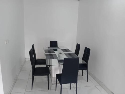 a dining room with a table with a laptop on it at Luxury 2- Apartment Furnished luxury residence in Cocody