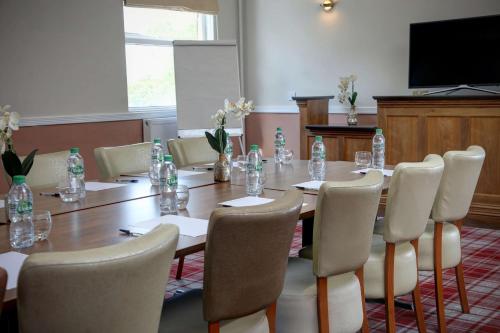 a conference room with a long table and chairs at Trafford Hall Hotel Manchester, Trademark Collection by Wyndham in Manchester