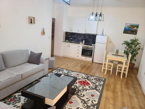 a living room with a couch and a table at Apartment Center Tirana in Tirana