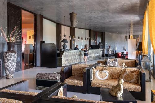 a living room with two couches and a bar at Amareclub Baia Dei Turchi Resort - Adults Only in Otranto