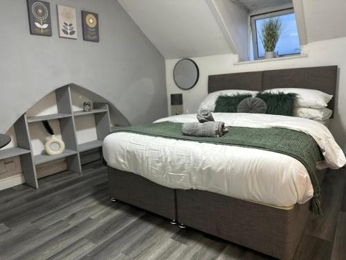 a bedroom with a large bed and a window at Studio Flat Near City Centre in Newport