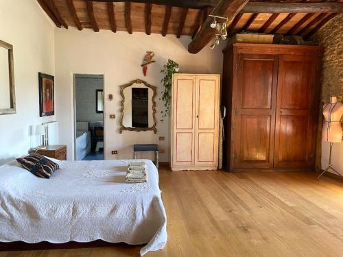 una camera da letto con un letto e un pavimento in legno di Farmhouse with pool in the Chianti a Montefiridolfi