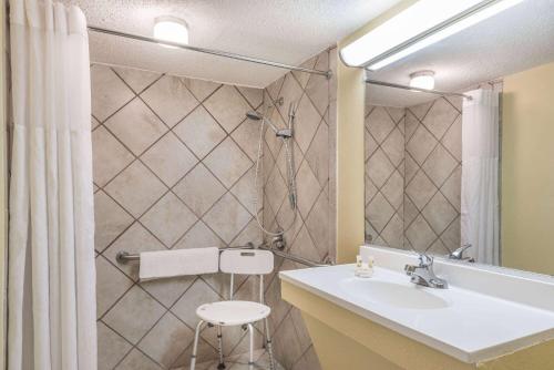 a bathroom with a sink and a shower at Ramada by Wyndham Lumberton in Lumberton